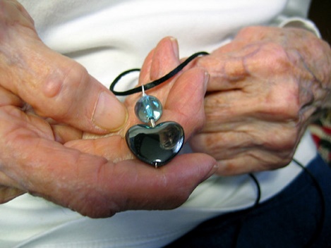 Helen LaBar holds an Earth Link pendant